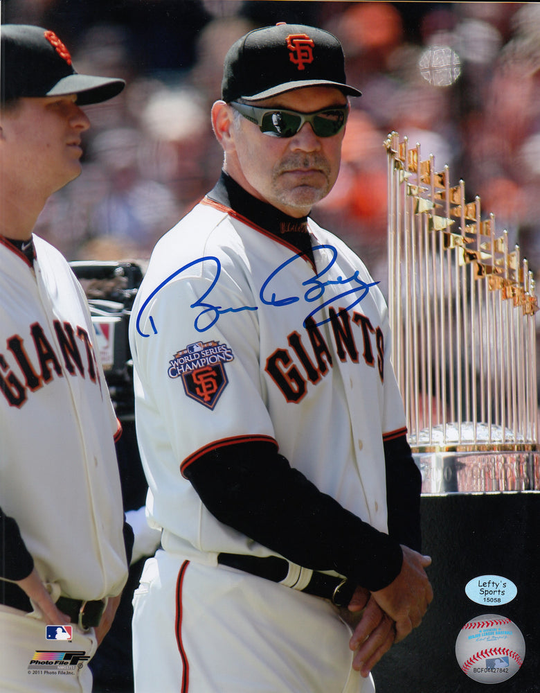 
                
                    Load image into Gallery viewer, Bruce Bochy San Francisco Giants Autographed 8x10 Photo (Vertical, Standing With WS Trophy, White Jersey)
                
            